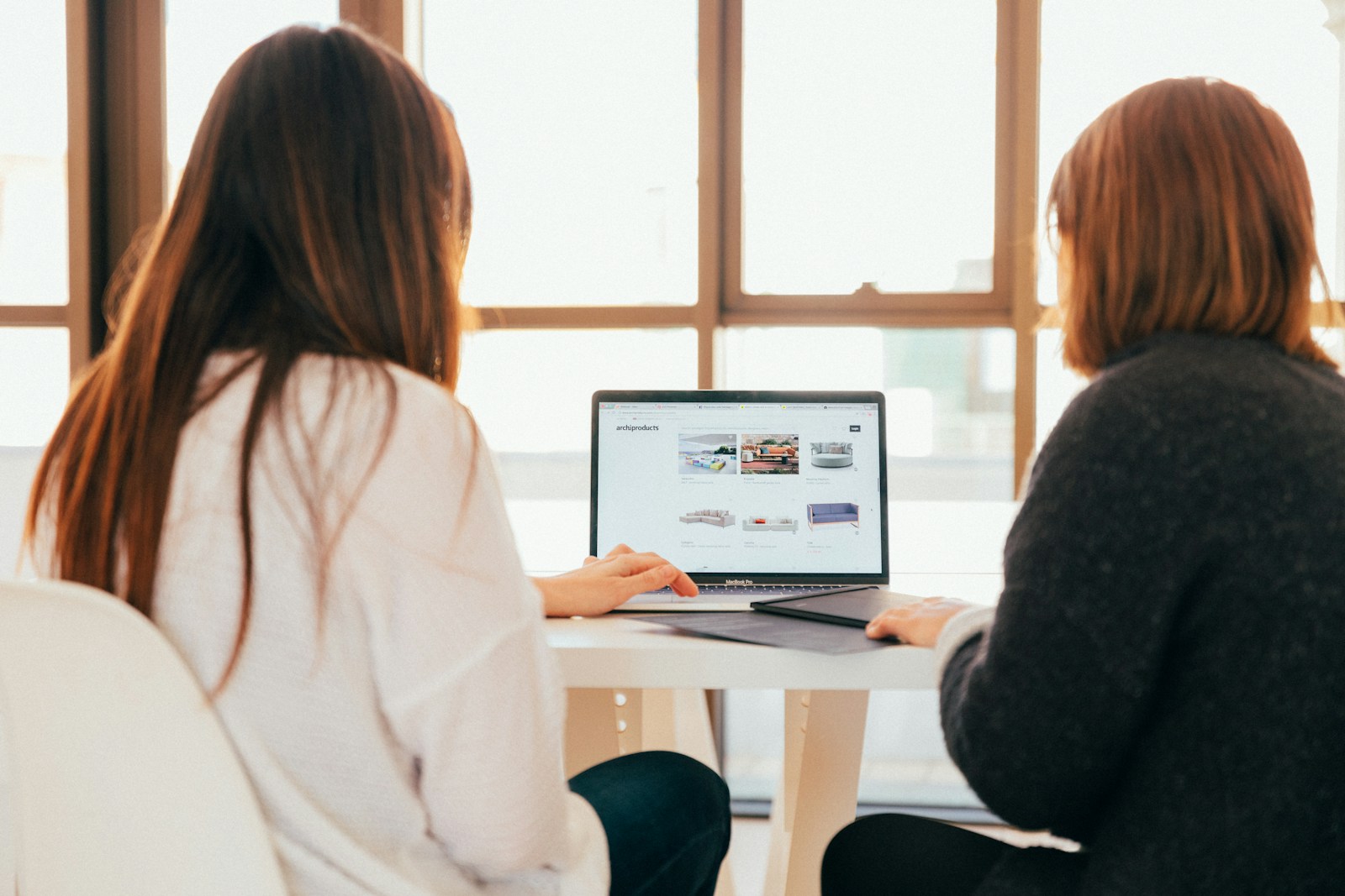 Marketing team collaborating on a laptop